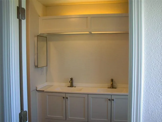 a bathroom with a sink and mirror