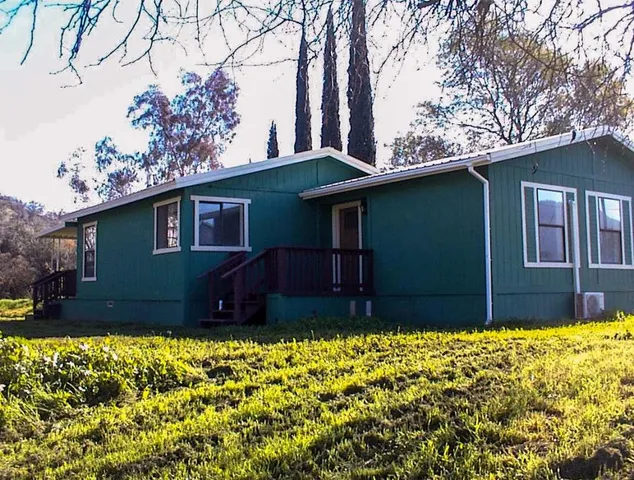 a view of house with yard