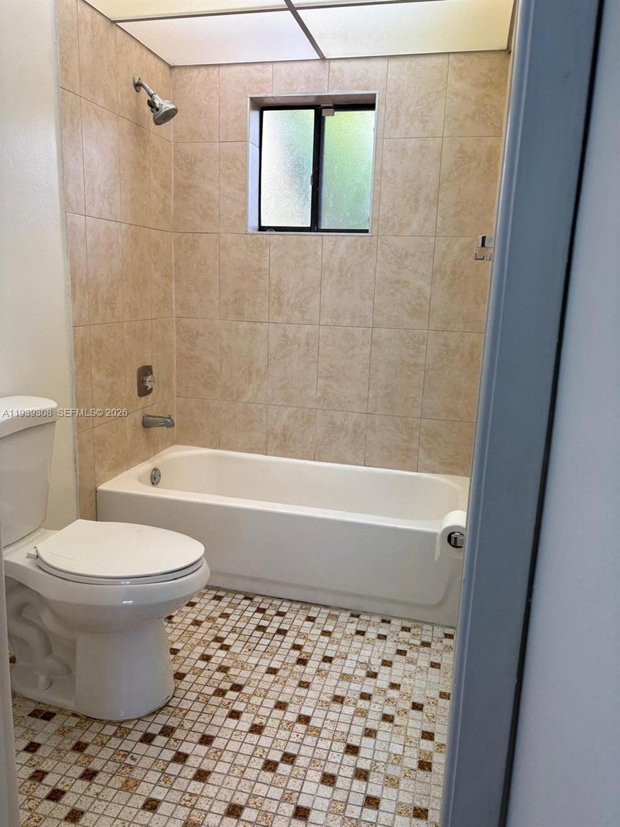 8700 Southwest 133rd Avenue Road, Unit 409 Miami, FL 33183 - Photo 9 of 10 a bathroom with a toilet and a shower