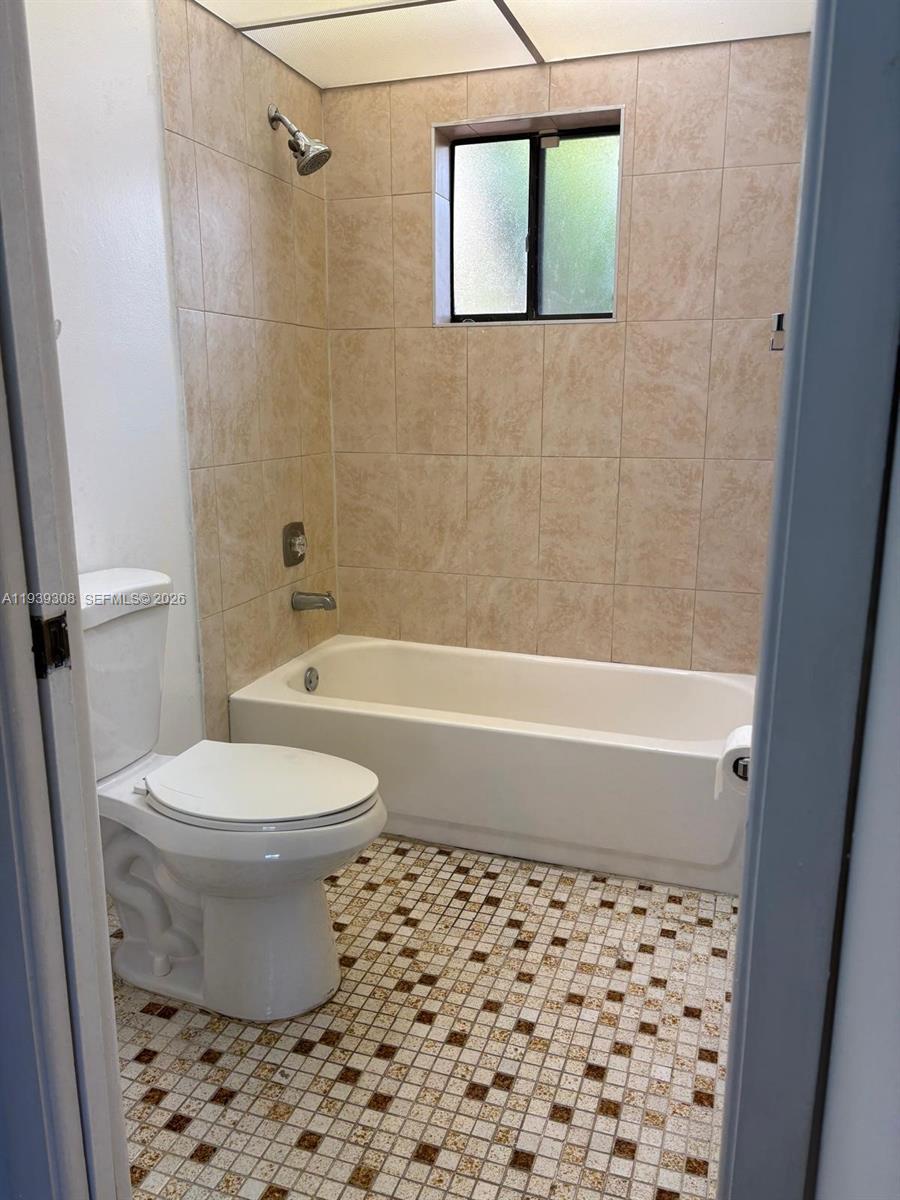 8700 Southwest 133rd Avenue Road, Unit 409 Miami, FL 33183 - Photo 10 of 10 a bathroom with a toilet and a shower