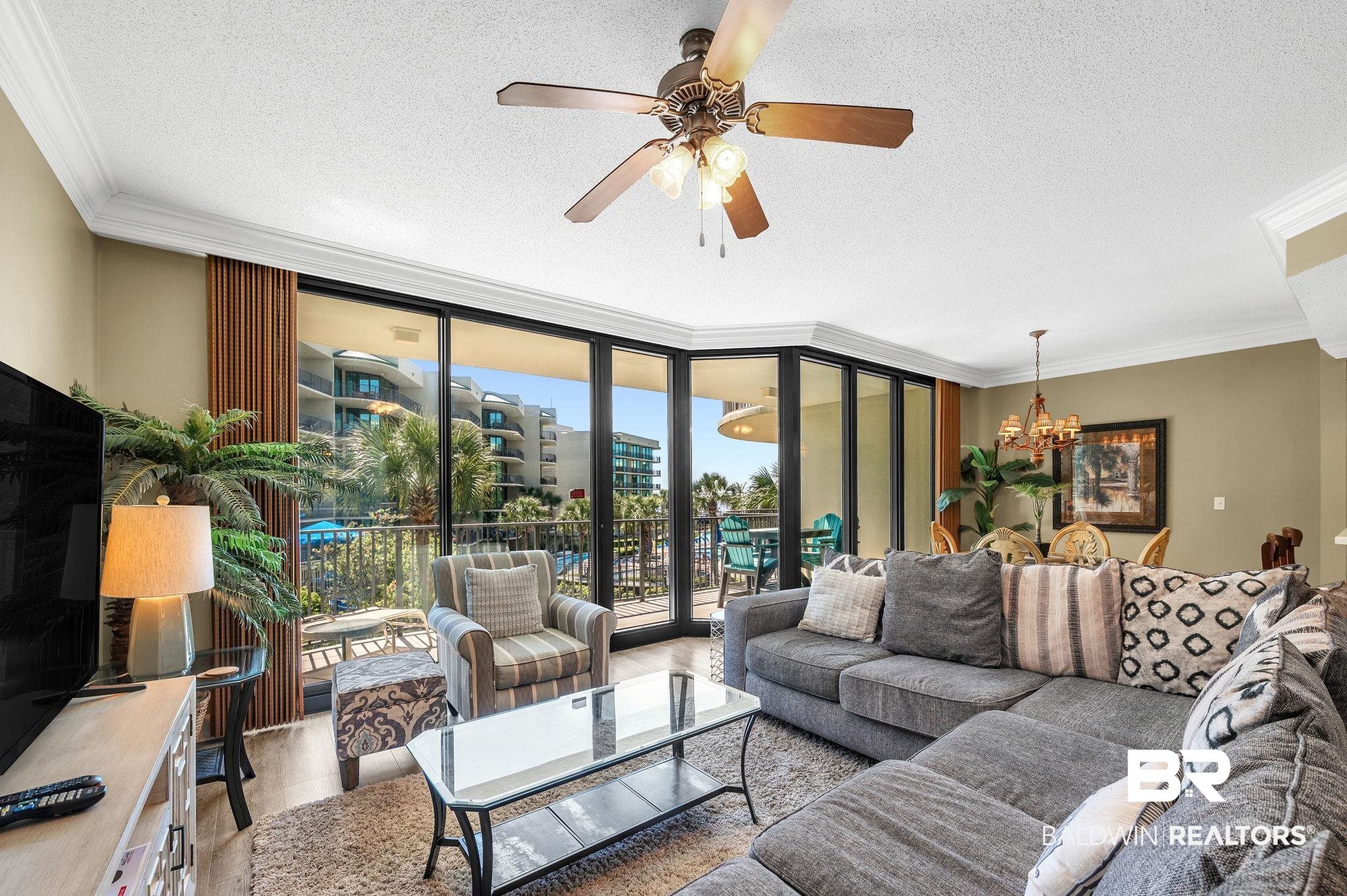 27580 Canal Road, Unit 1214 AND BOAT SLIP #62 Orange Beach, AL 36561 - Photo 7 of 67 Living area with expansive windows, a textured ceiling, ornamental molding, and wood finished floors