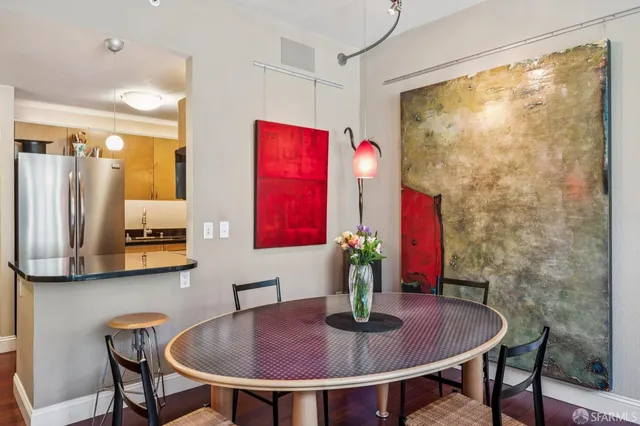 a dining room with furniture and wooden floor