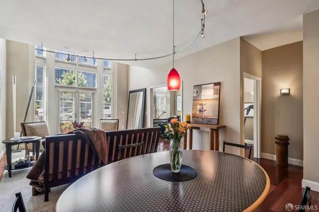 a dining room with furniture a chandelier and wooden floor