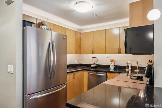 a kitchen with stainless steel appliances a refrigerator and a stove top oven