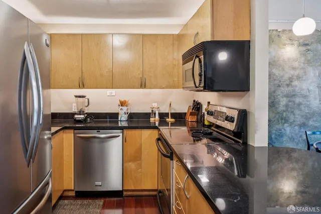 a kitchen with stainless steel appliances a microwave a stove and a refrigerator