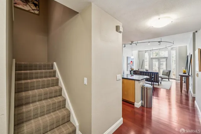 a view of a kitchen with furniture and wooden floor