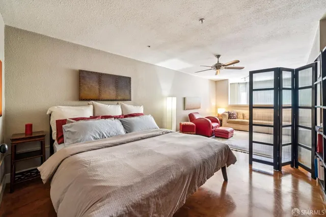 a bedroom with two beds and a flat screen tv