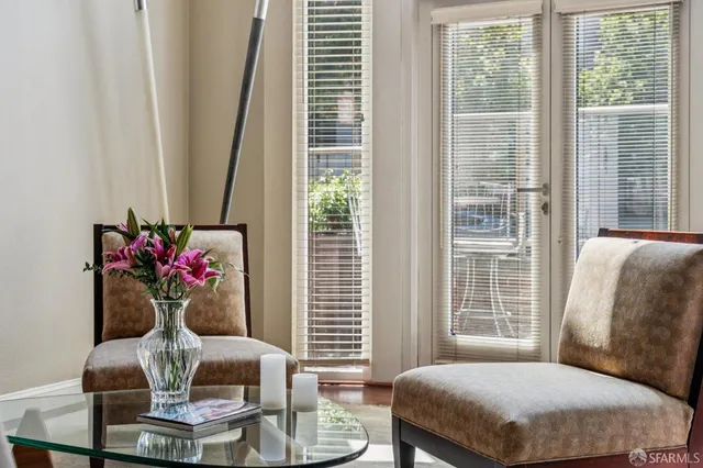 a living room with furniture and potted plant
