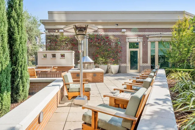 a view of a patio with couches table and chairs and potted plants