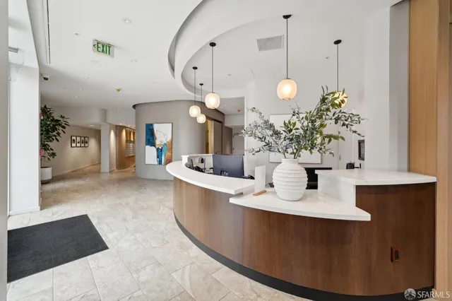 a large room with a table chairs and a chandelier