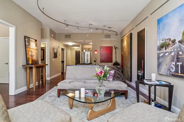 a living room with furniture and kitchen view