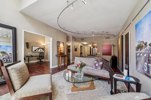 a living room with furniture and wooden floor