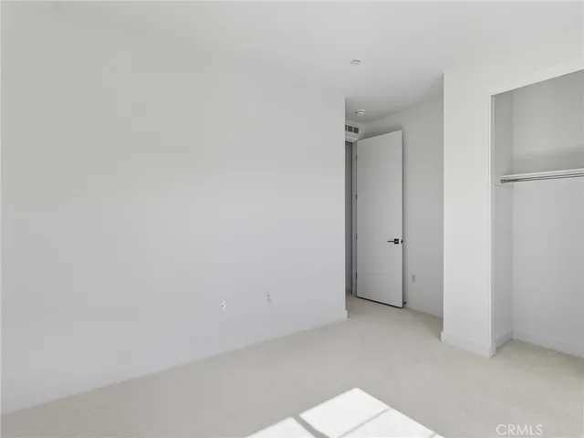 an empty room with a empty space and windows