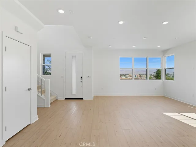 a view of kitchen with refrigerator and window