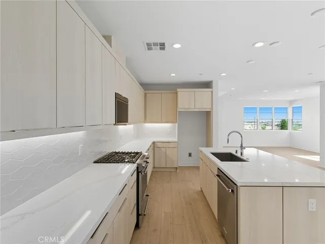 a kitchen that has a sink and a stove in it
