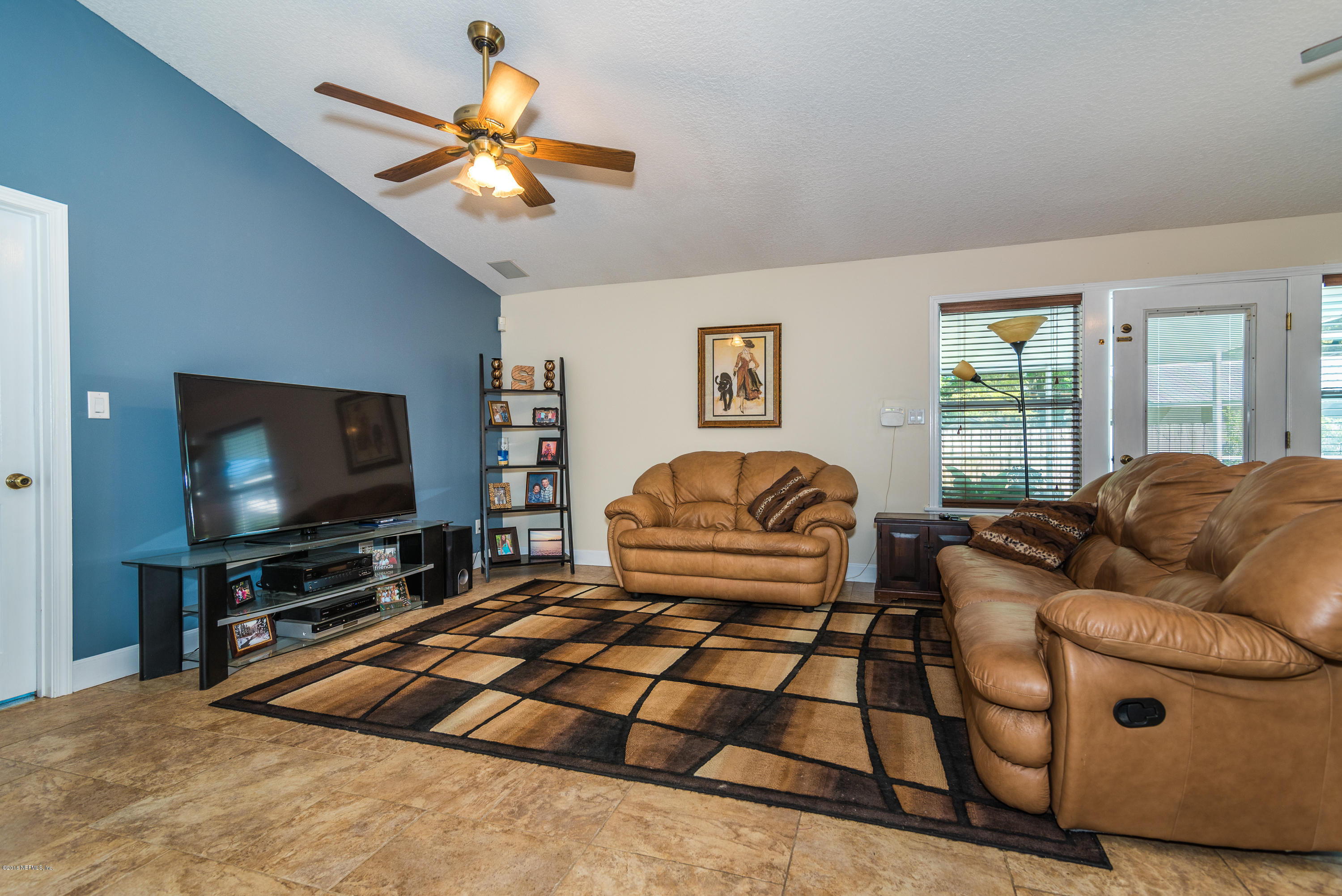 707 Warbler Road St. Augustine, FL 32086 - Photo 11 of 37 a living room with furniture a flat screen tv and a window