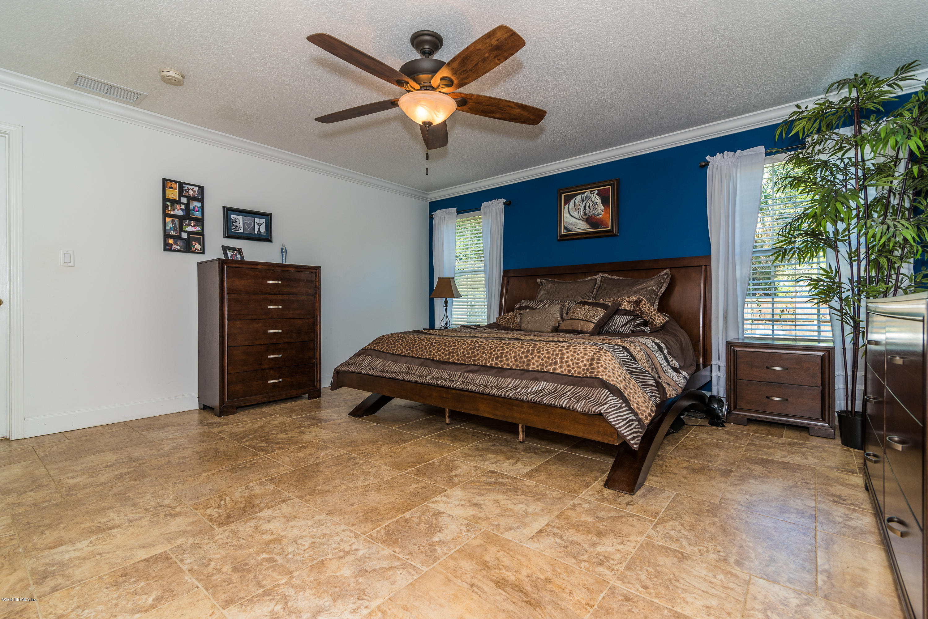 707 Warbler Road St. Augustine, FL 32086 - Photo 14 of 37 a bedroom with a bed and a dresser