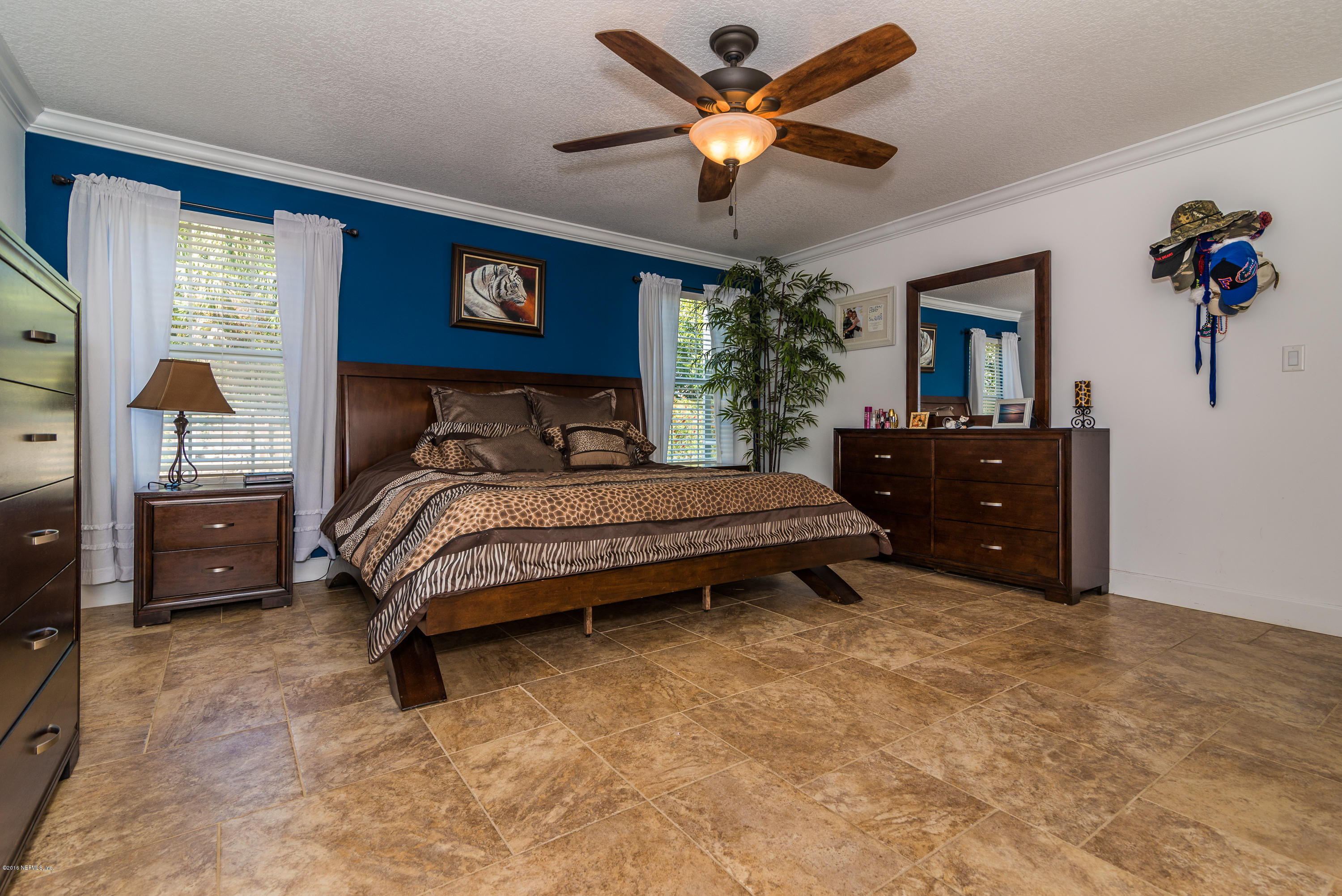 707 Warbler Road St. Augustine, FL 32086 - Photo 15 of 37 a bedroom with a bed and a chandelier