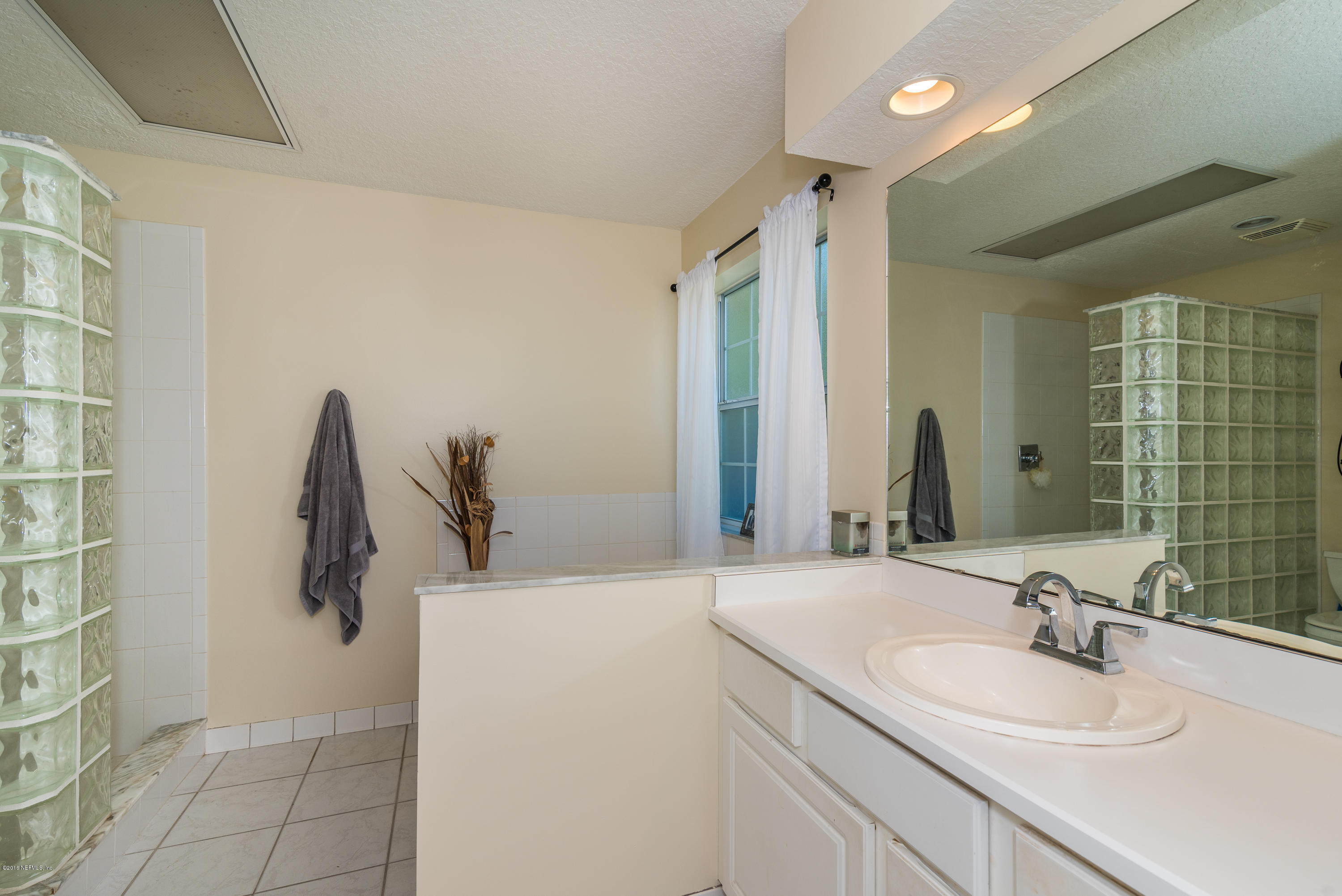 707 Warbler Road St. Augustine, FL 32086 - Photo 17 of 37 a bathroom with a sink and a mirror