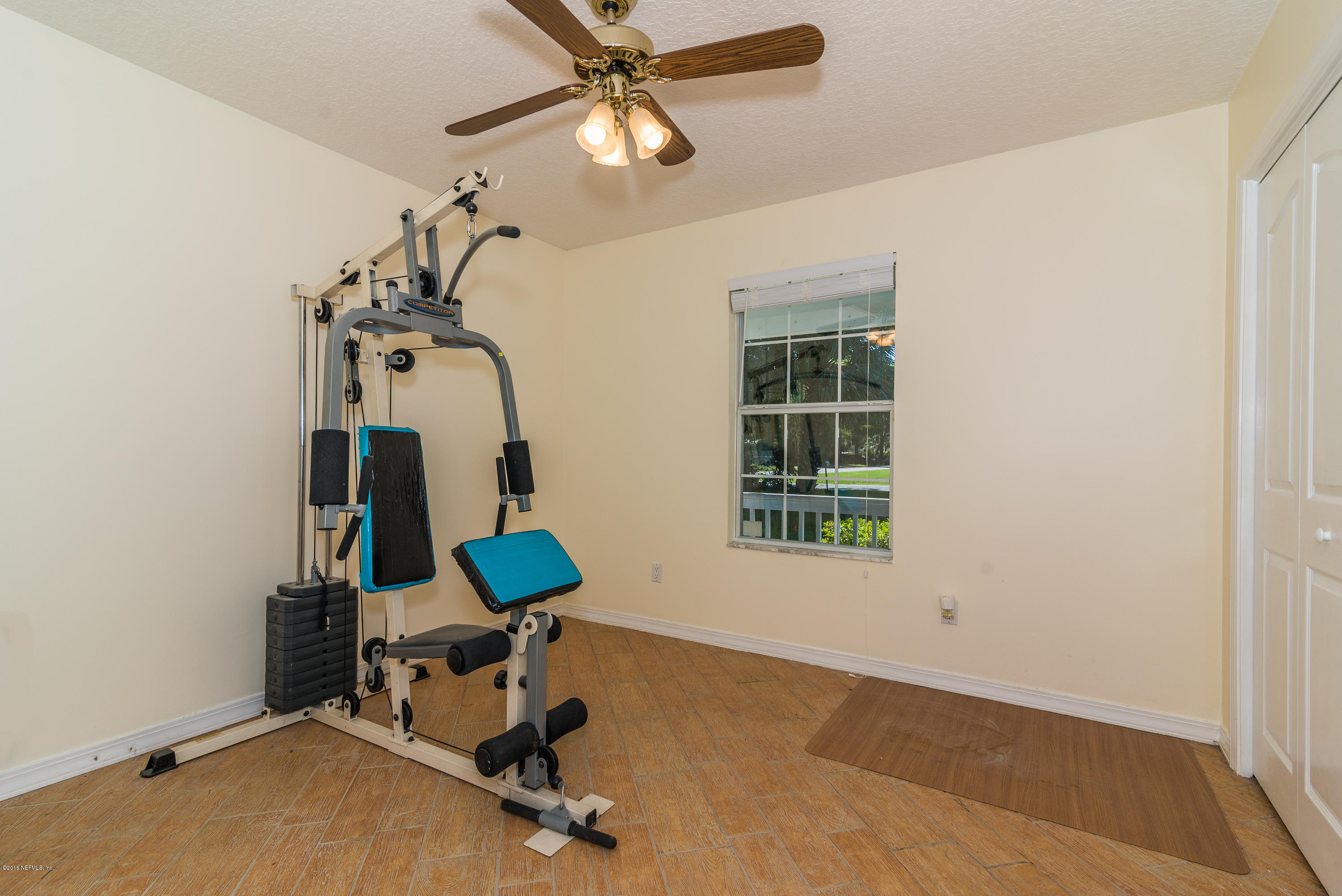 707 Warbler Road St. Augustine, FL 32086 - Photo 21 of 37 a room with gym equipment and windows