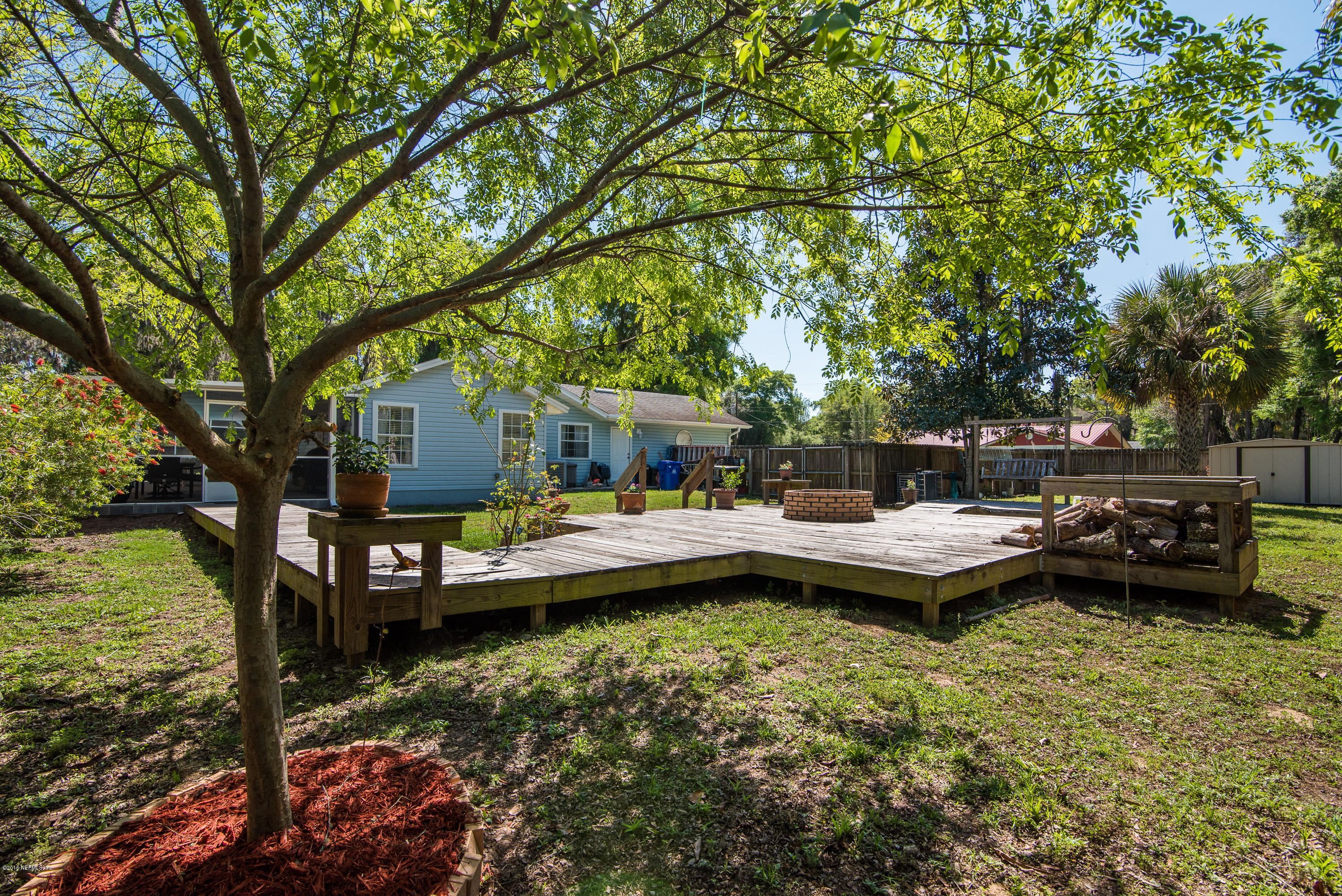 707 Warbler Road St. Augustine, FL 32086 - Photo 27 of 37 a view of a house with backyard sitting area and garden