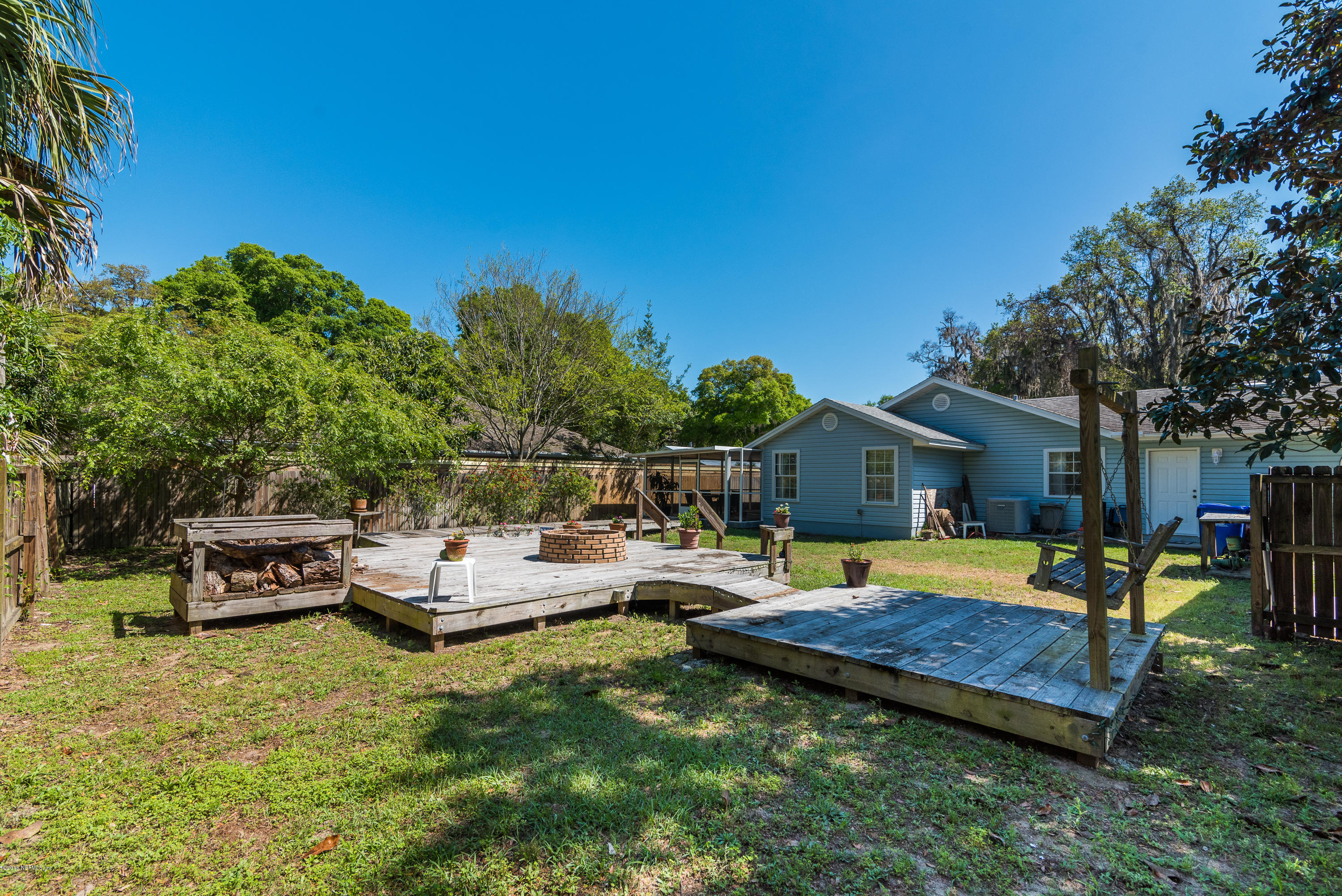 707 Warbler Road St. Augustine, FL 32086 - Photo 28 of 37 a view of a house with backyard water fountain and sitting area