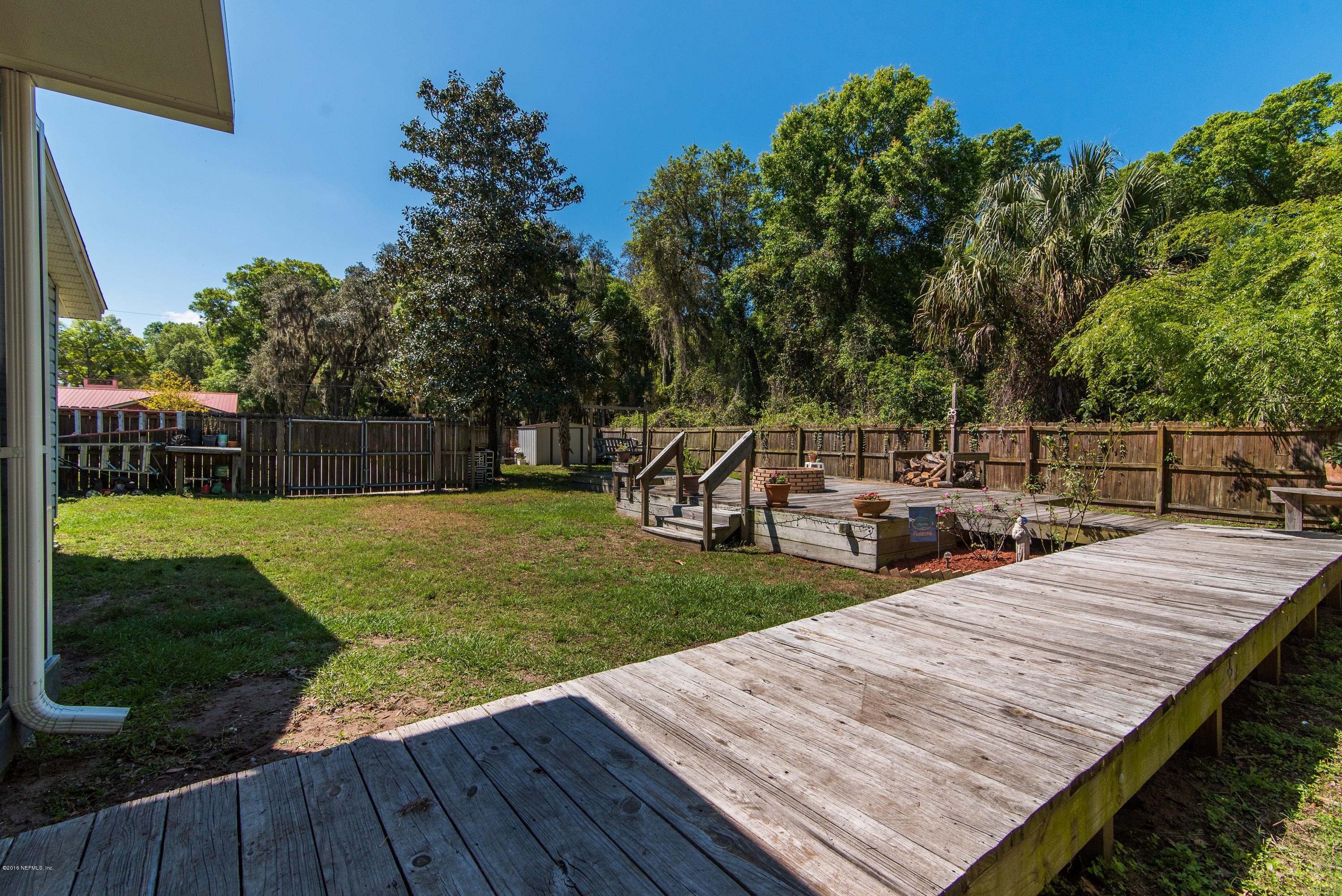 707 Warbler Road St. Augustine, FL 32086 - Photo 32 of 37 a view of a wooden deck and a yard