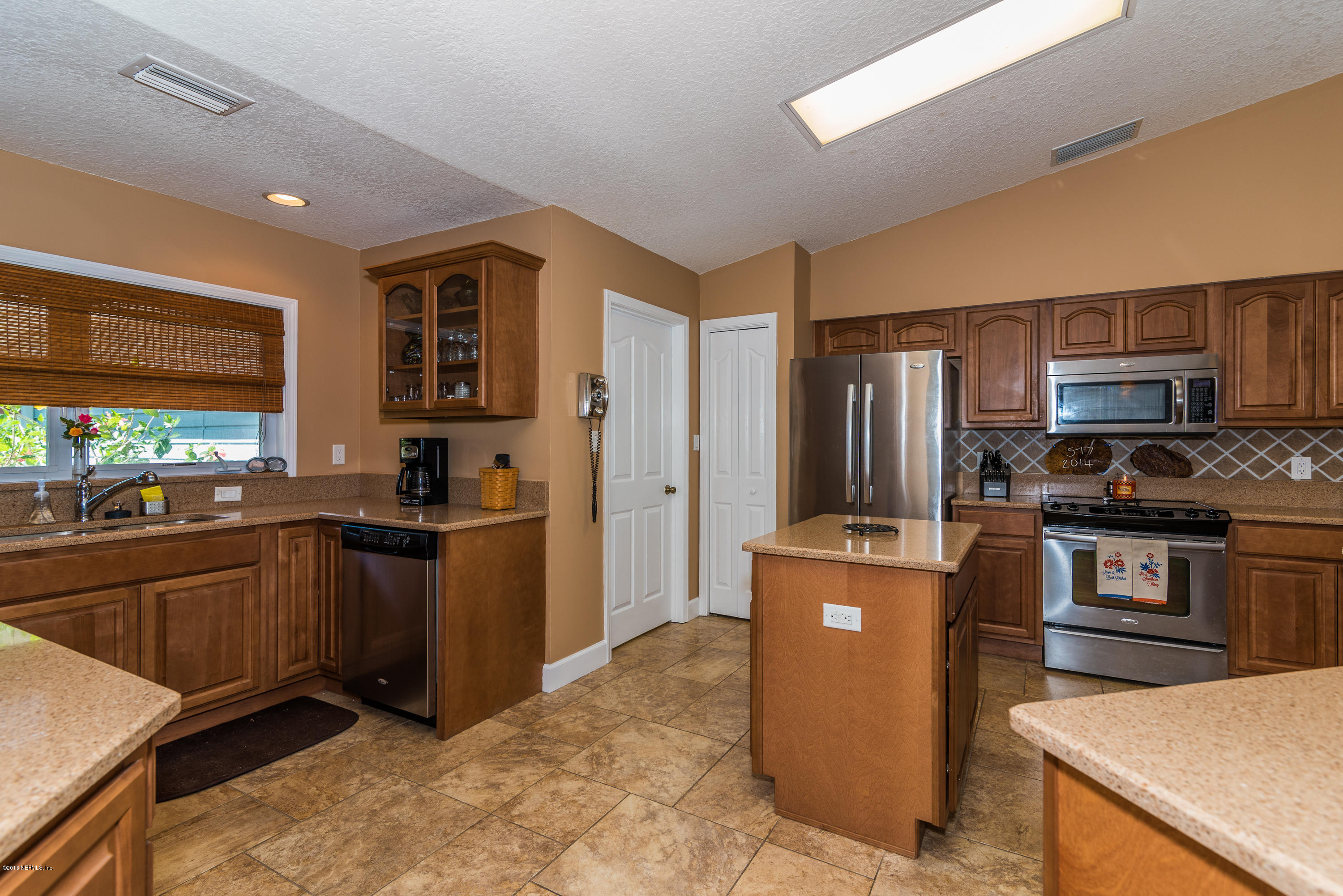 707 Warbler Road St. Augustine, FL 32086 - Photo 7 of 37 a kitchen with stainless steel appliances granite countertop a refrigerator stove top oven and sink