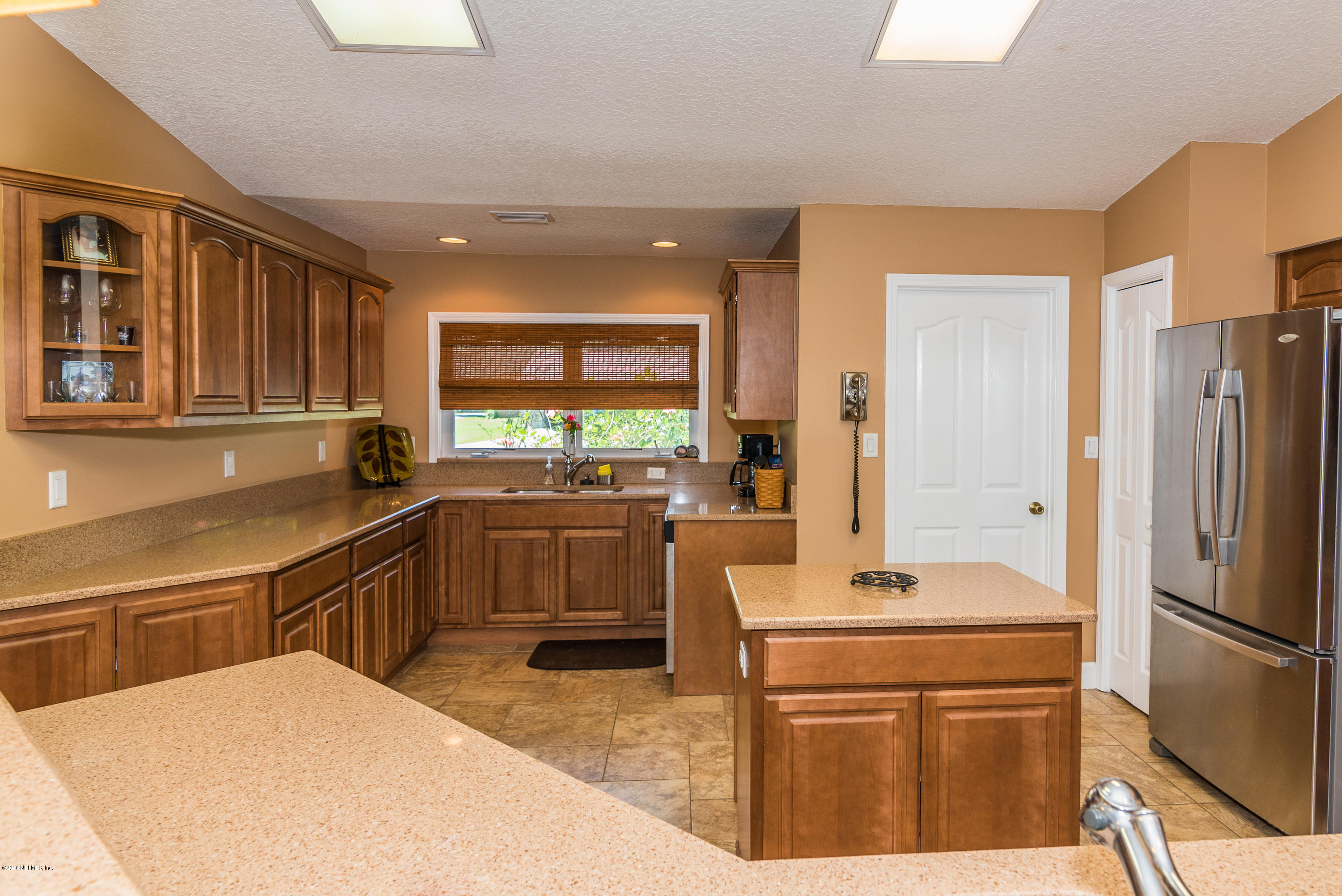 707 Warbler Road St. Augustine, FL 32086 - Photo 8 of 37 a kitchen with a refrigerator and a sink