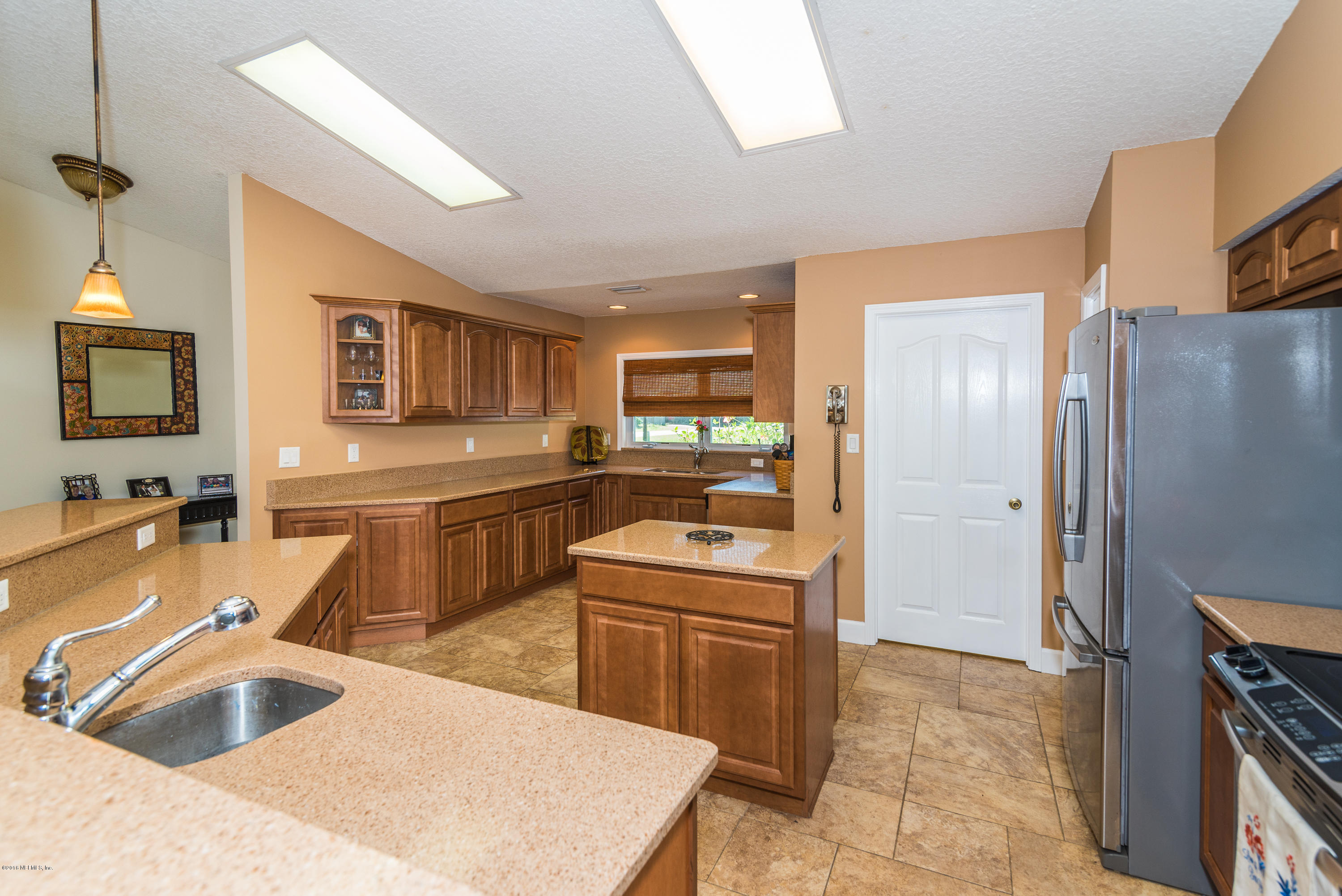 707 Warbler Road St. Augustine, FL 32086 - Photo 9 of 37 a kitchen with granite countertop a sink stove and refrigerator