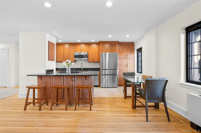 a bed sitting in a bedroom next to a window with chair