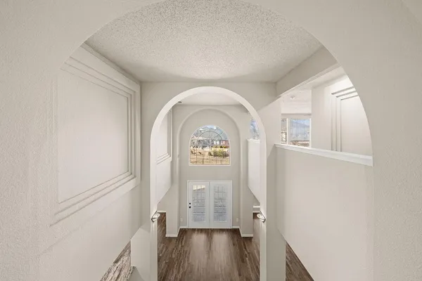 a view of entryway with wooden floor