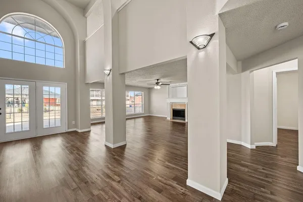 a view of an entryway with wooden floors and a fireplace