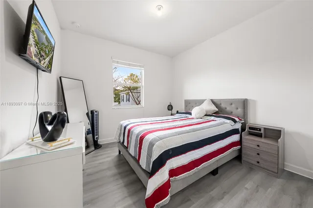 a bedroom with a bed and a flat screen tv