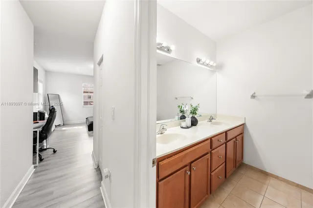 a bathroom with a sink a mirror and a shower