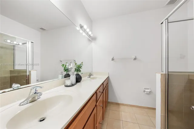 a bathroom with a sink and a large mirror