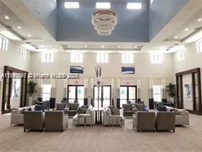 a living room with lots of furniture and chandelier