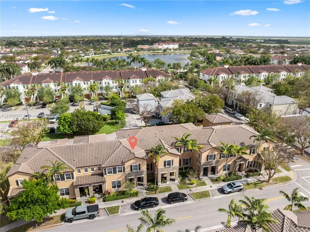 an aerial view of residential houses with outdoor space