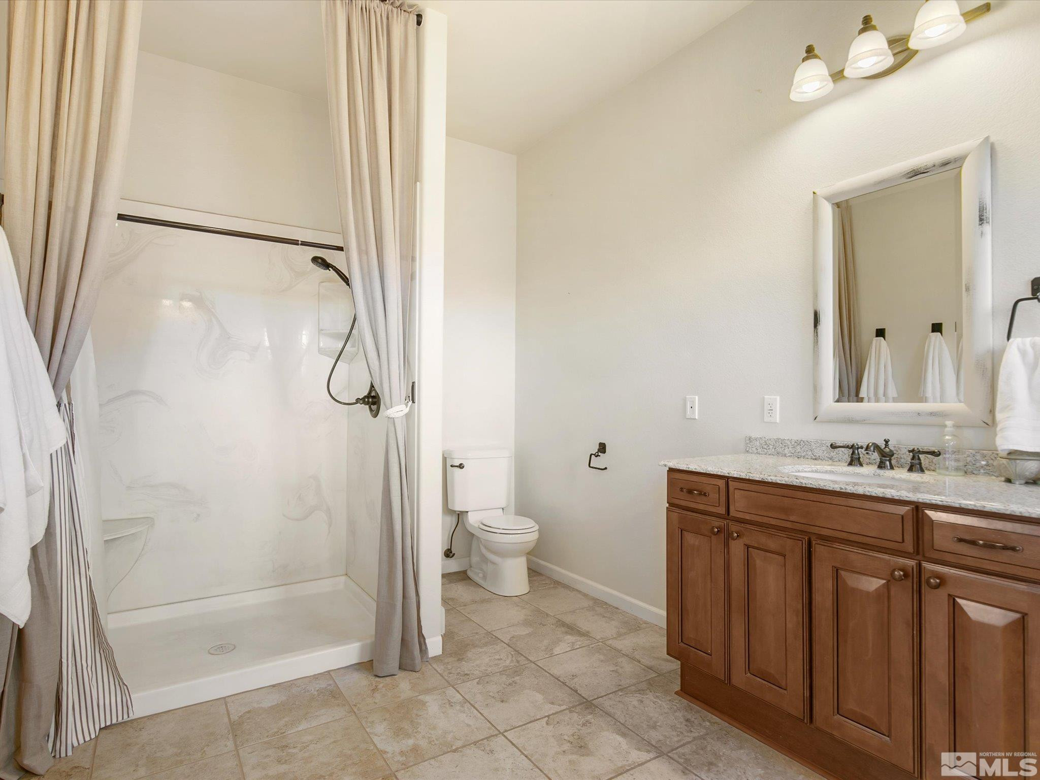 6900 Grass Valley Road Reno, NV 89510 - Photo 20 of 42 a bathroom with a double vanity sink toilet and shower