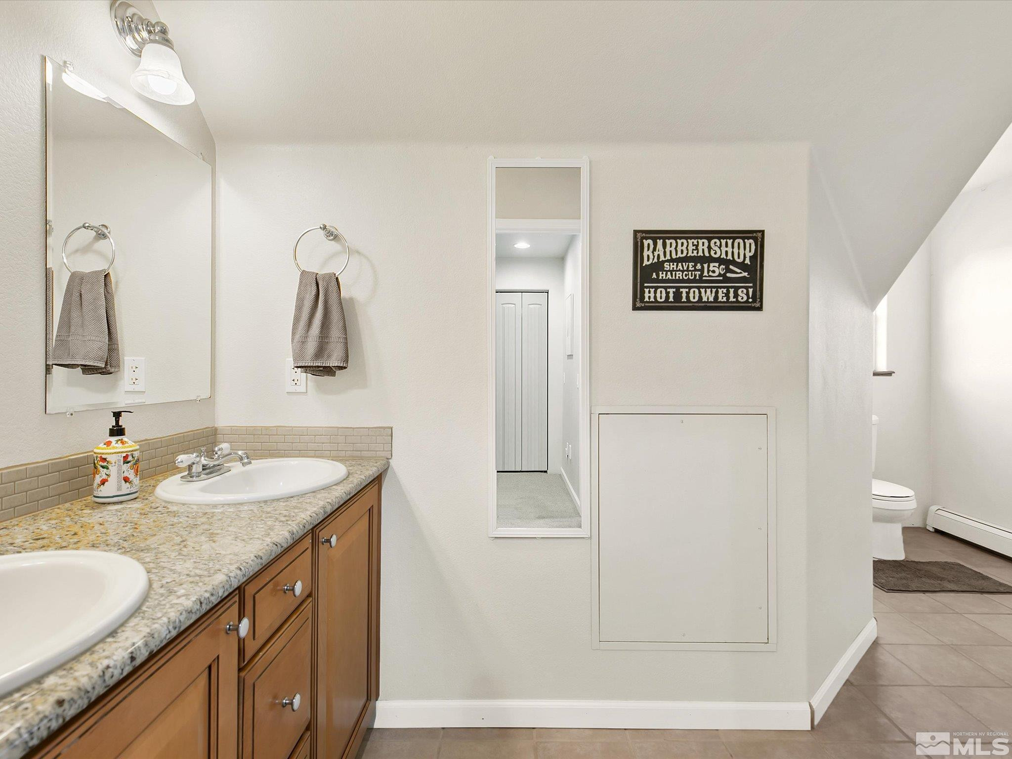 6900 Grass Valley Road Reno, NV 89510 - Photo 25 of 42 a bathroom with a granite countertop sink and a mirror