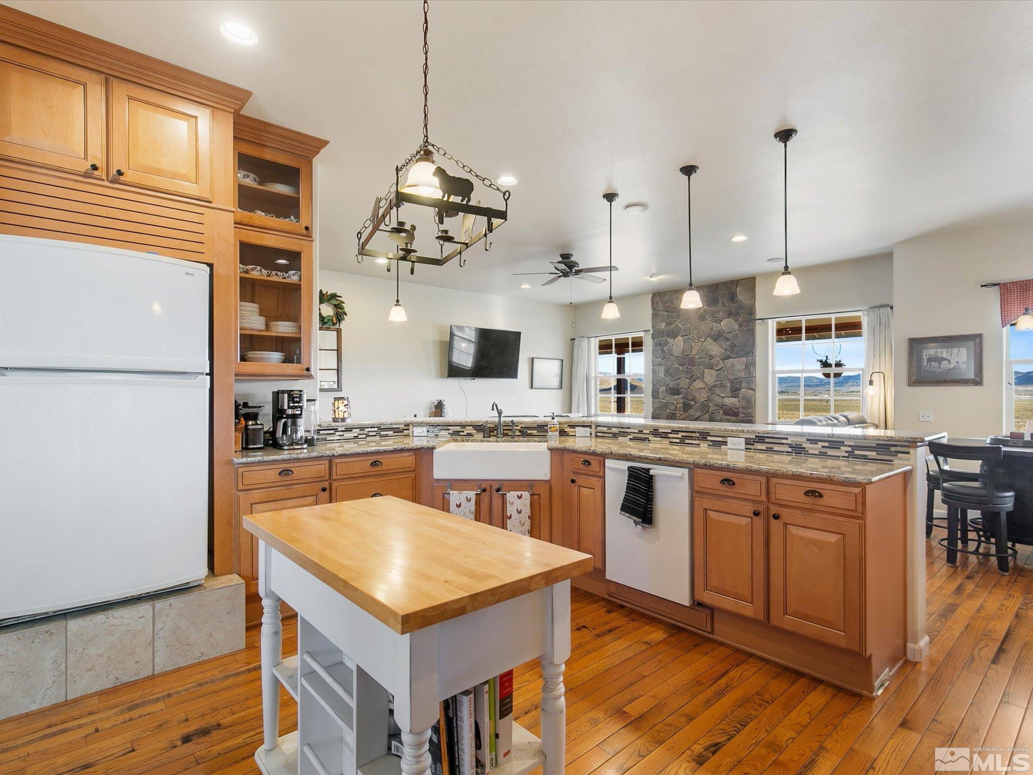 6900 Grass Valley Road Reno, NV 89510 - Photo 10 of 42 a kitchen with stainless steel appliances granite countertop stove a sink dishwasher and a refrigerator with wooden floor