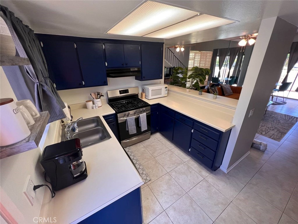 69646 Antonia Way Rancho Mirage, CA 92270 - Photo 13 of 50 a kitchen with wooden cabinets and a sink