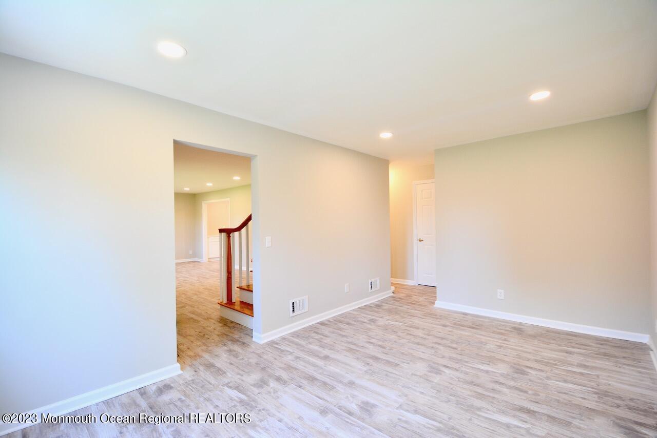 6 Wickatunk Road Manalapan, NJ 07726 - Photo 15 of 35 an empty room with wooden floor and a painting