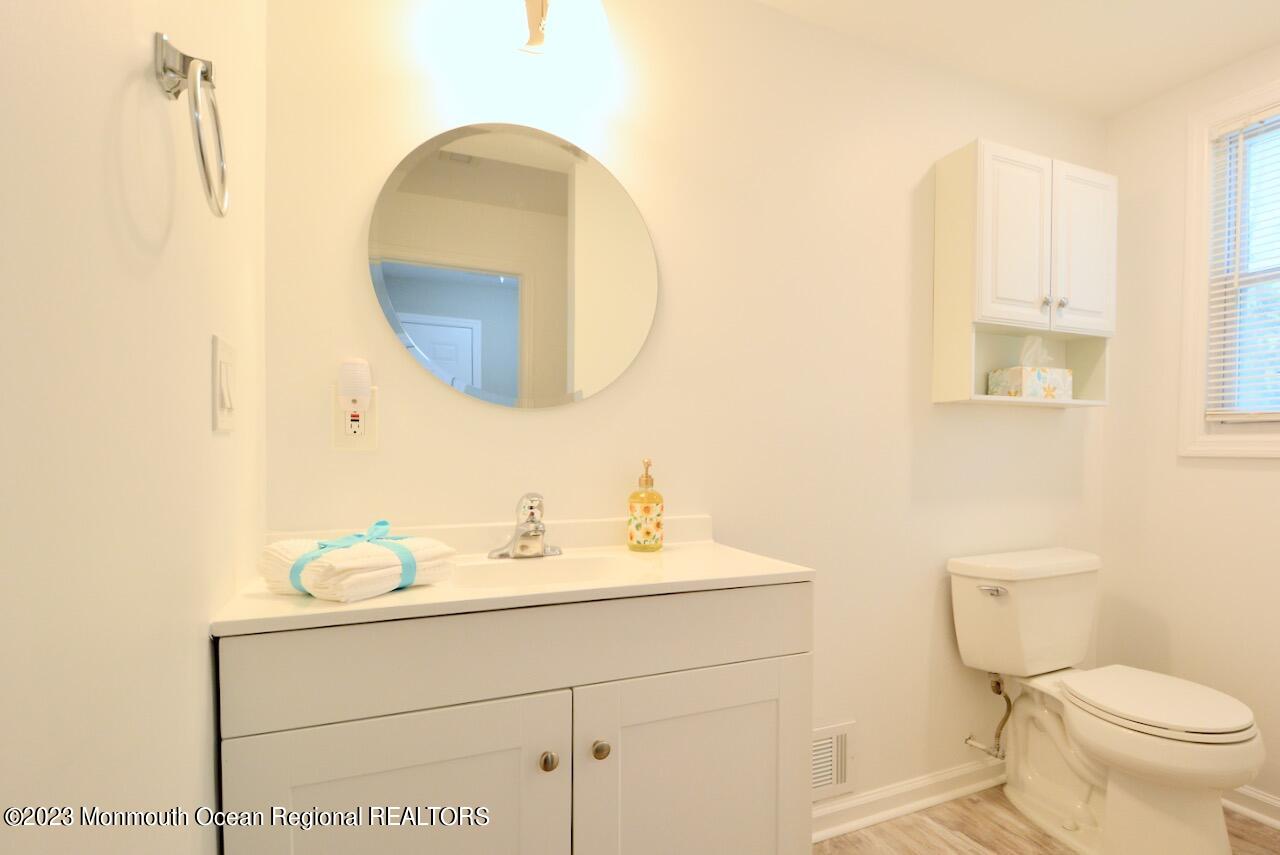 6 Wickatunk Road Manalapan, NJ 07726 - Photo 18 of 35 a bathroom with a toilet sink and mirror