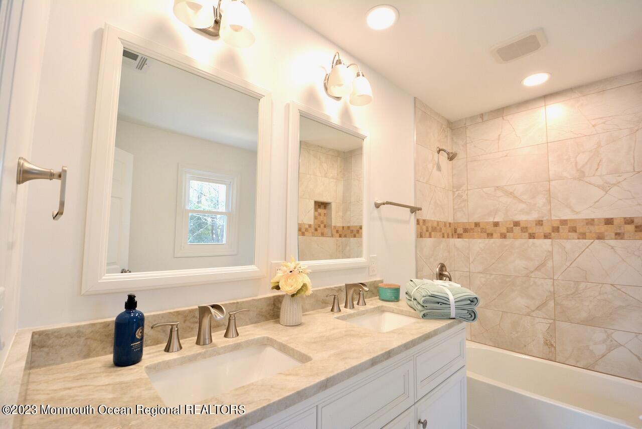 6 Wickatunk Road Manalapan, NJ 07726 - Photo 24 of 35 a bathroom with a granite countertop sink and a mirror