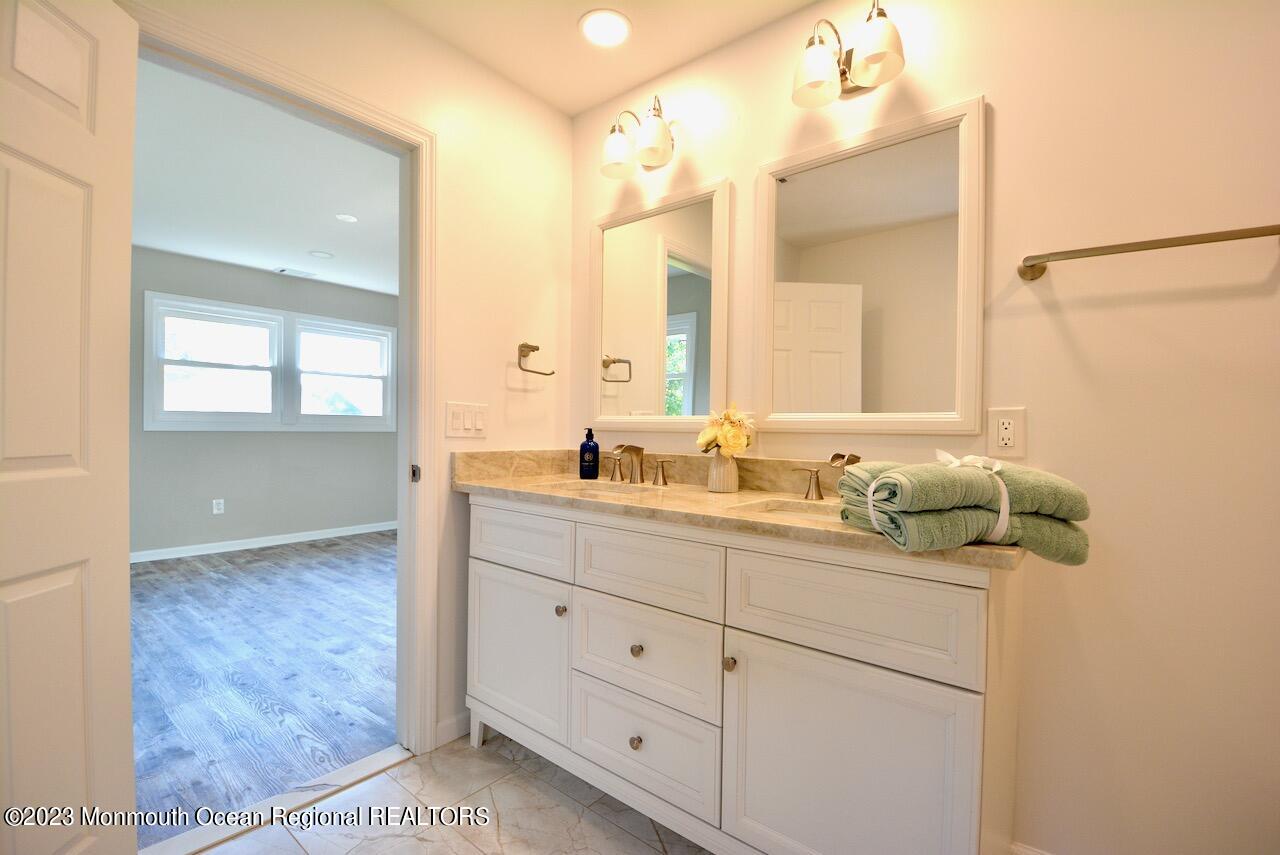 6 Wickatunk Road Manalapan, NJ 07726 - Photo 25 of 35 a bathroom with a sink and mirror