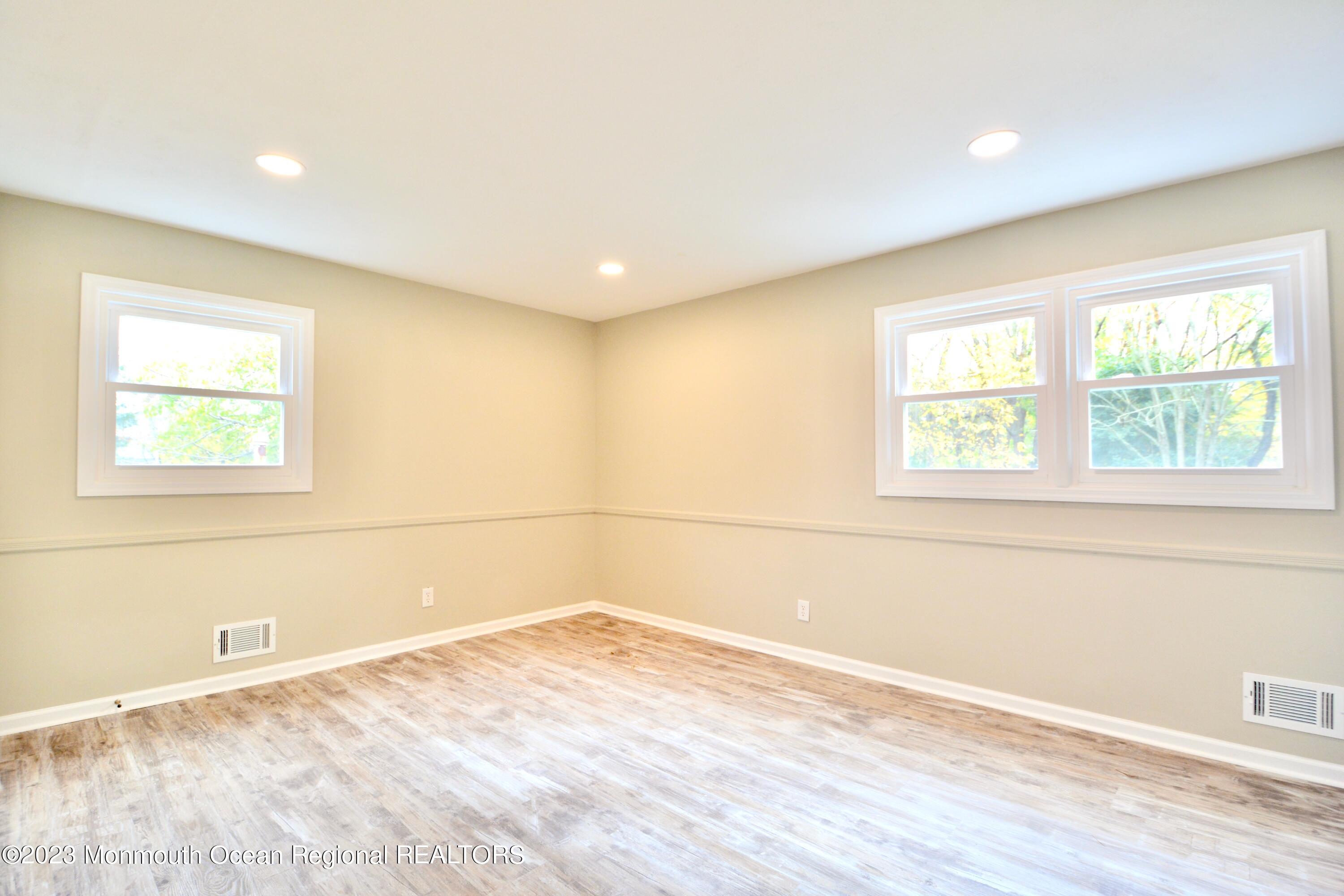6 Wickatunk Road Manalapan, NJ 07726 - Photo 26 of 35 an empty room with wooden floor and windows