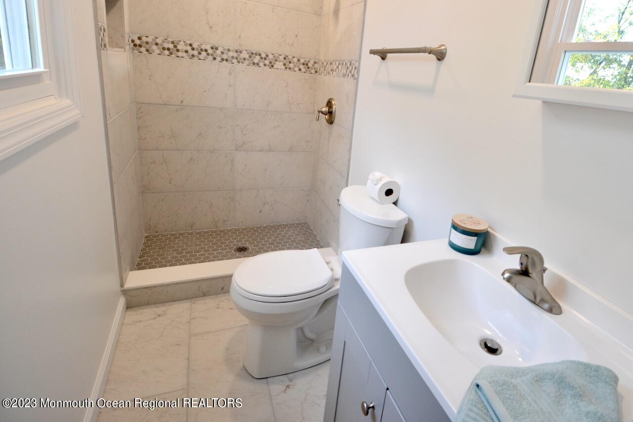 6 Wickatunk Road Manalapan, NJ 07726 - Photo 28 of 35 a bathroom with a sink and a toilet