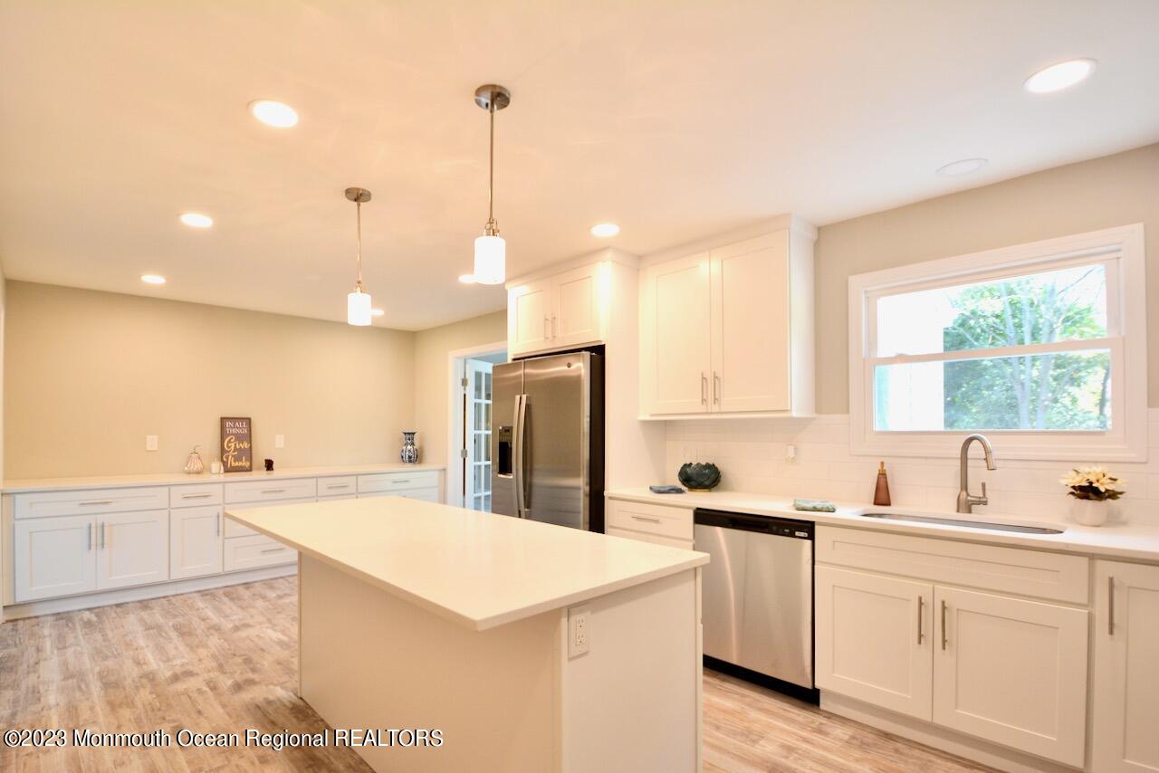 6 Wickatunk Road Manalapan, NJ 07726 - Photo 3 of 35 a kitchen that has a sink a counter top space stainless steel appliances and a window