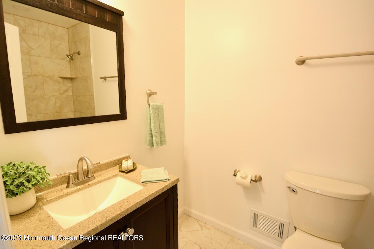 6 Wickatunk Road Manalapan, NJ 07726 - Photo 32 of 35 a bathroom with a sink and a mirror